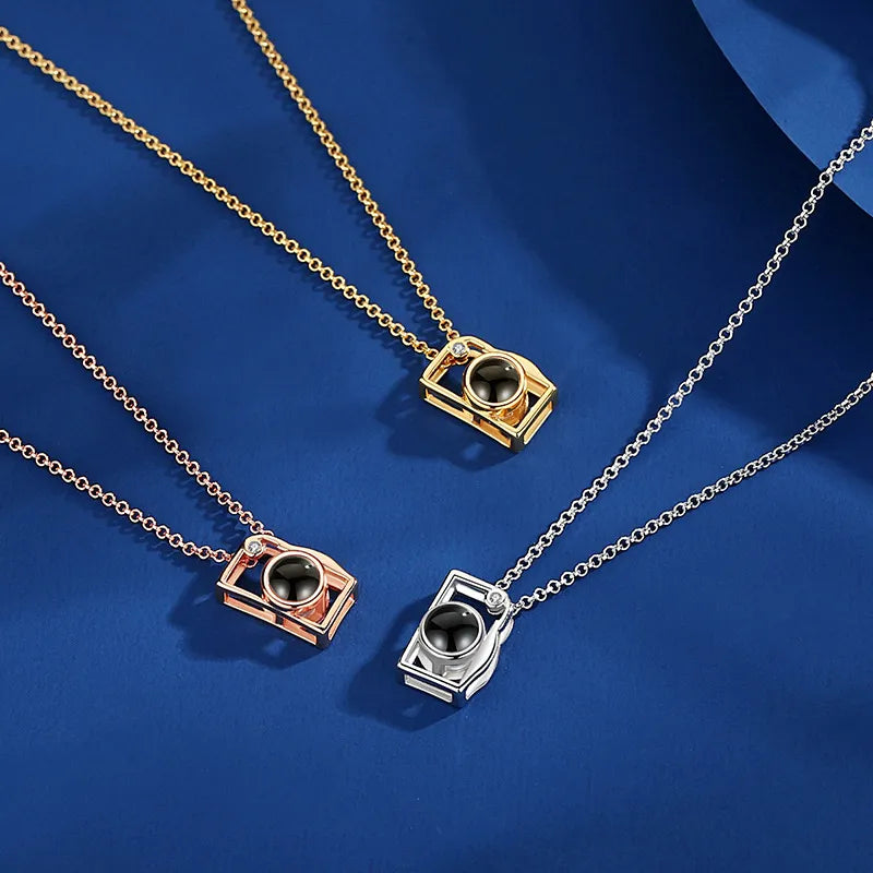 Close-up of camera photo projection necklace pendant