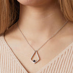 Woman wearing a polygon photo projection necklace