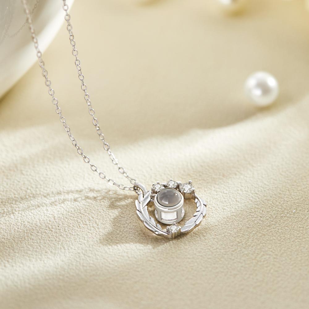 Close-up of wreath photo projection necklace pendant