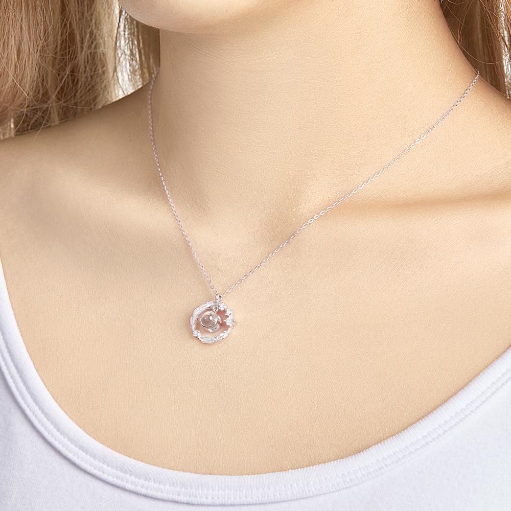 Woman wearing a wreath photo projection necklace