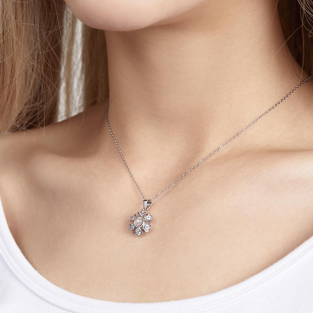 Woman wearing a flower photo projection necklace