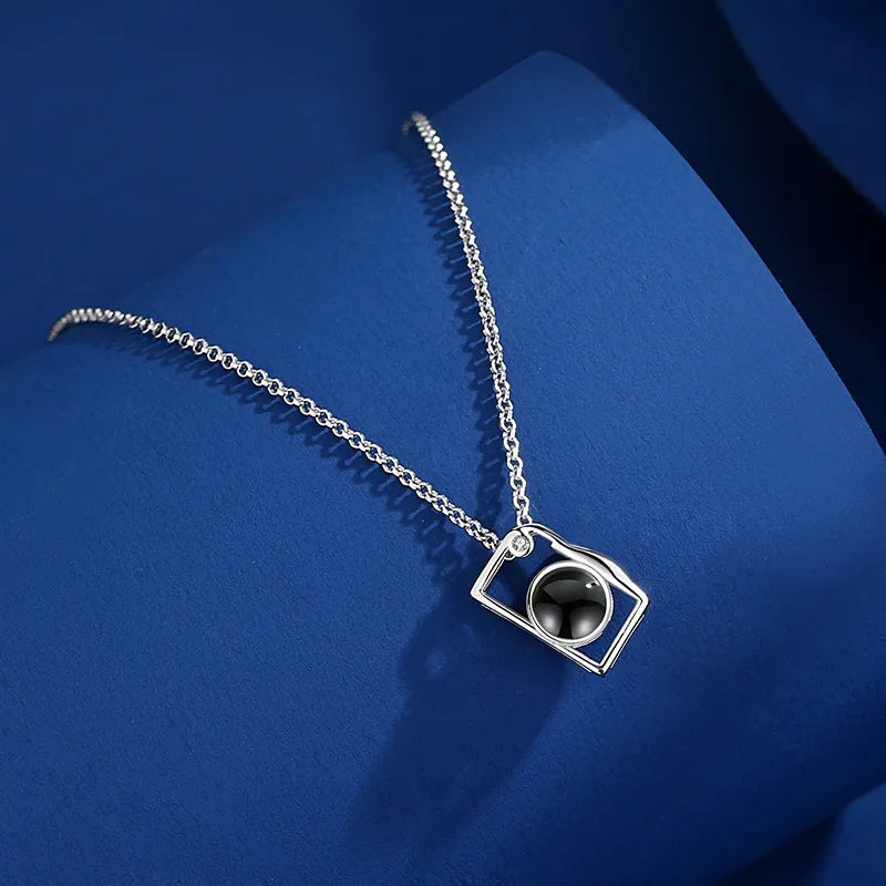 Close-up detail of the camera photo projection necklace